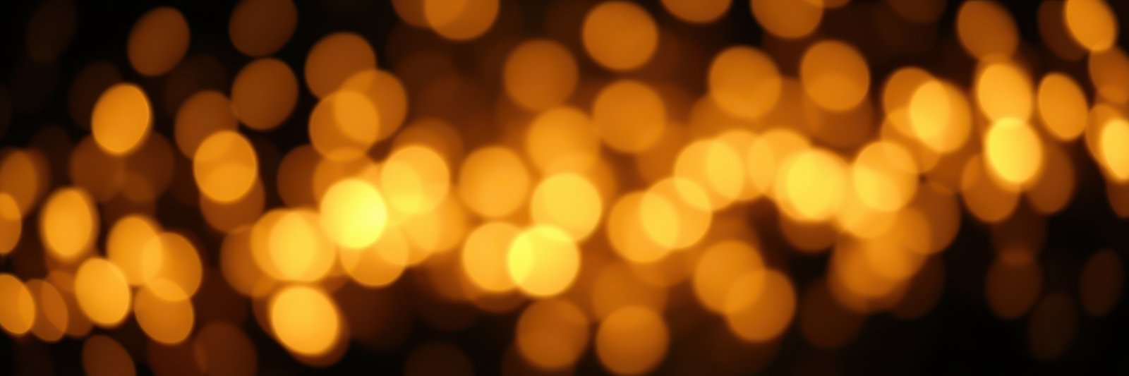Bokeh lights create a warm ambiance during a celebration at night, illuminating the surroundings